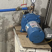 blue well pump in basement
